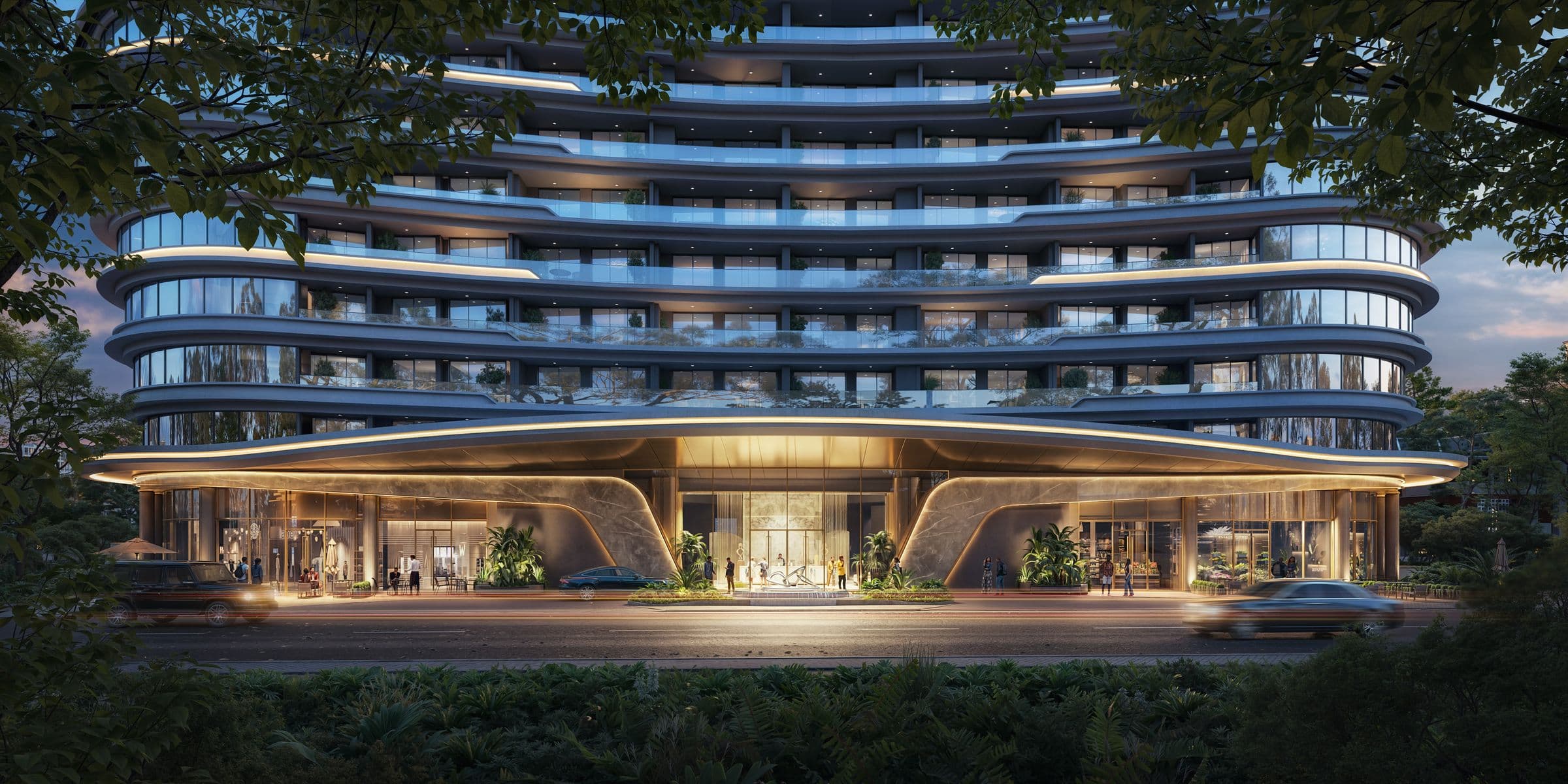 The lit entrance canopy of Cheval Riverside at night, with a resident walking in