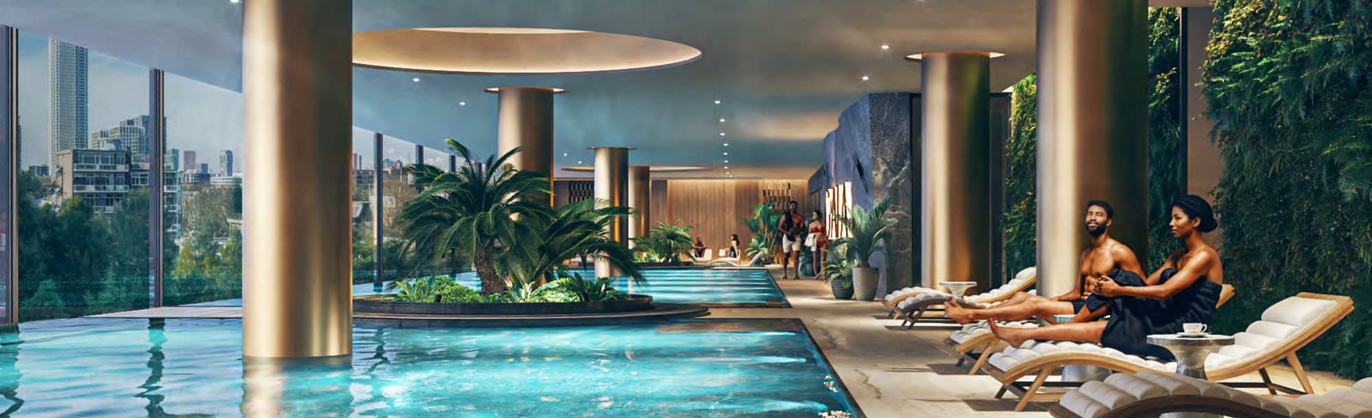The indoor pool with loungers and tropical planting